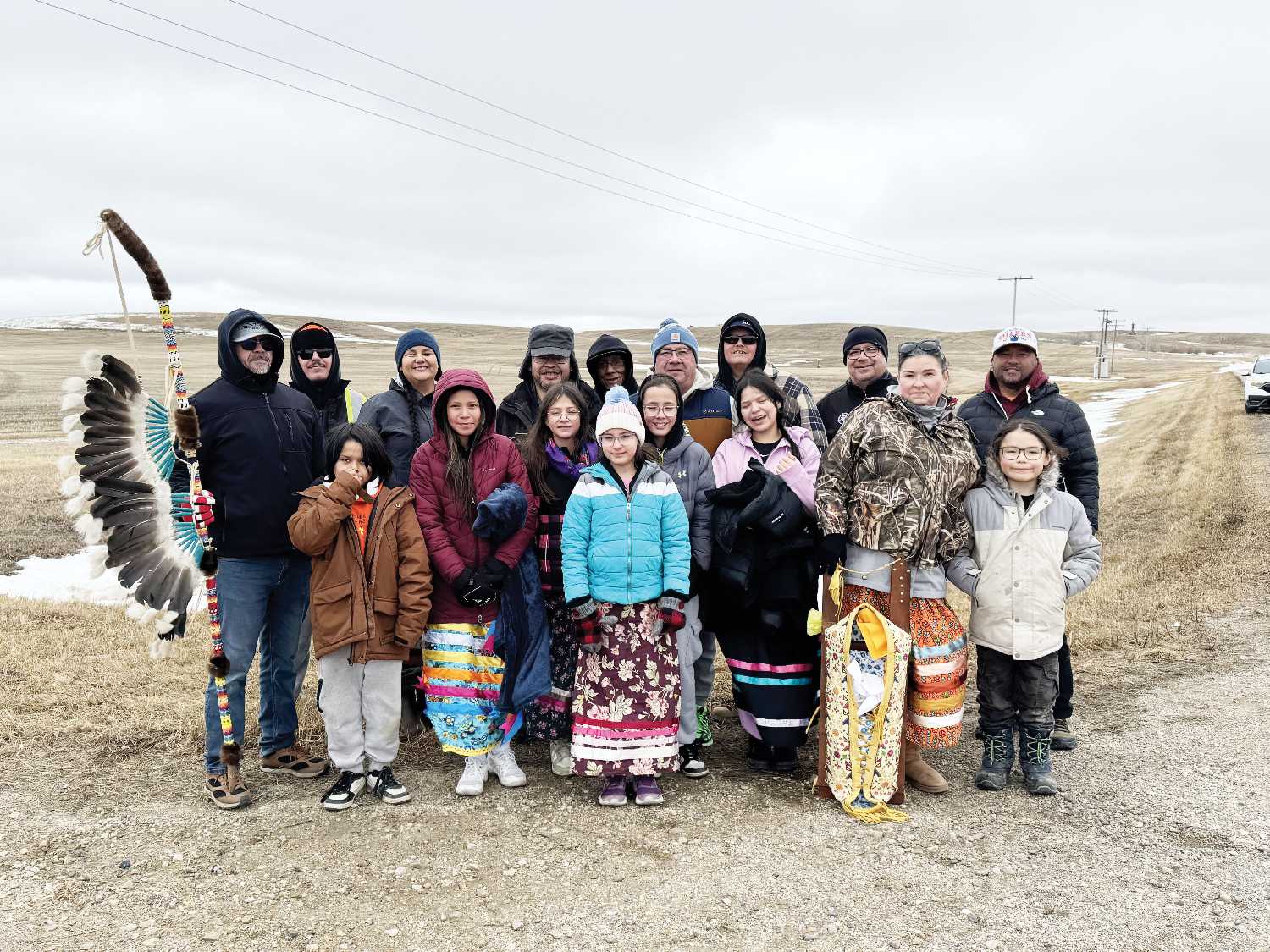 The Indigenous walk included, back row from left holding the Pheasant Rump Nakota First Nations (PRNFN) staff Patrick McArthur, Patrick Jr. Watcheston, Chenoa McArthur, Charlie Maxie, Aaron McArthur, PRNFN Chief Ira McArthur, Charlie BigEagle, Ocean Man First Nation Chief Ernest StandingReady, and White Bear First Nation Chief Jonathan Pasap. Front row from left are Theo Brown, Lemiyah Pasap, Blake Wolfe-McArthur, Amaya Wolfe-McArthur, Camden Wolfe-McArthur, Karrah Pasap, Juanita McArthur-BigEagle and Alaska Blue. 